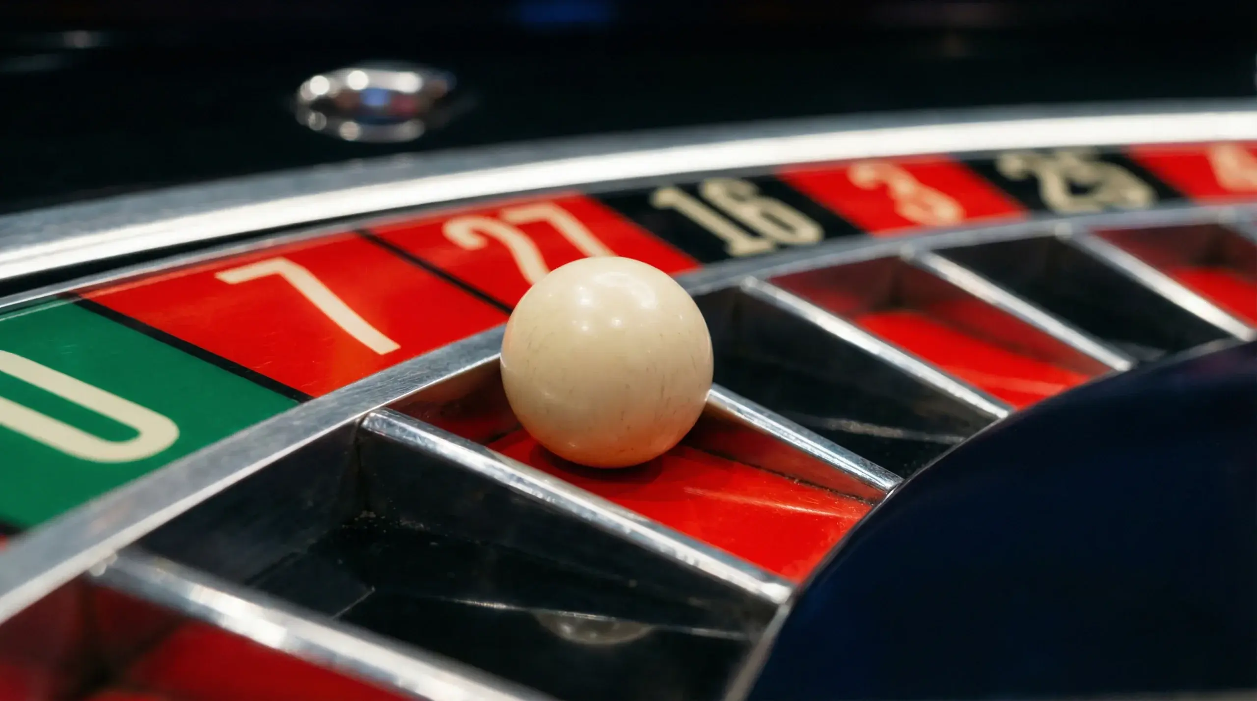 Roulette ball landing in numbered pocket showing game odds concept